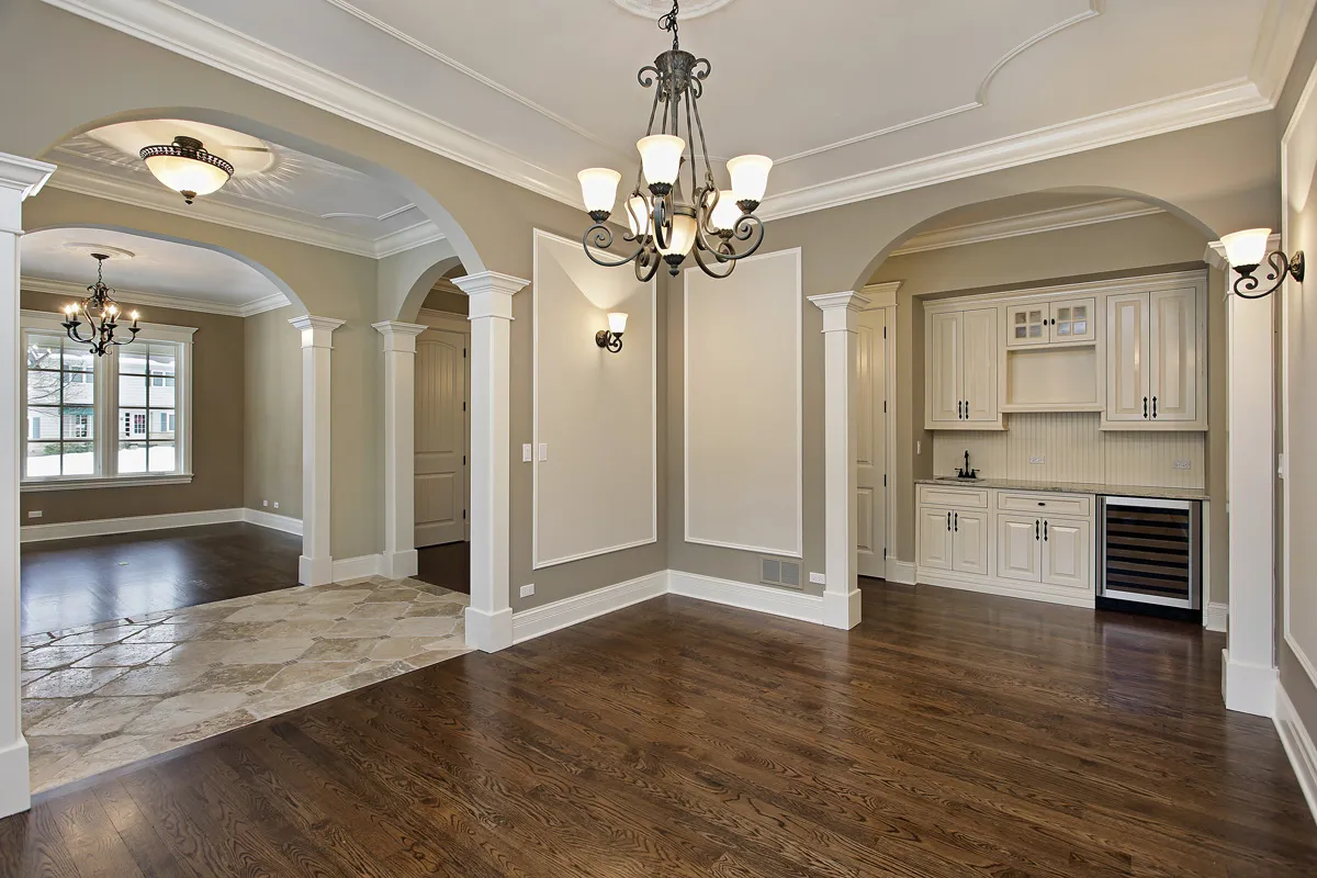 Dining room with columns, arched openings and crown moulding